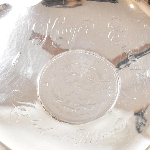 177 - A pair of early 20th century silver pin dishes or ash trays. The dishes containing Kruger coinage to... 