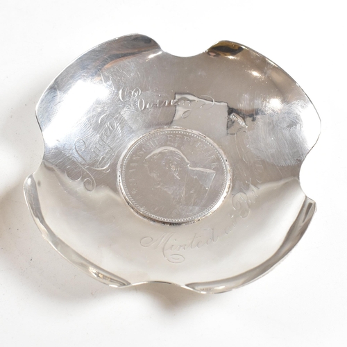 177 - A pair of early 20th century silver pin dishes or ash trays. The dishes containing Kruger coinage to... 