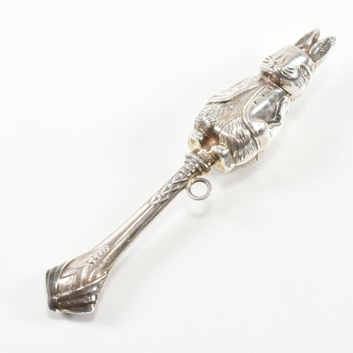 179 - A hallmarked silver rabbit rattle teether. The rattle in the form of a rabbit having a ribbon bale t... 