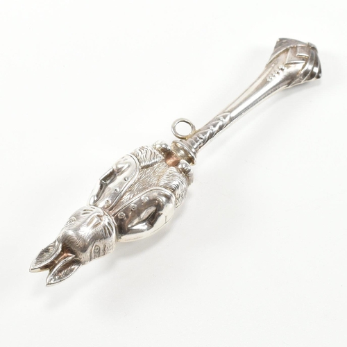 179 - A hallmarked silver rabbit rattle teether. The rattle in the form of a rabbit having a ribbon bale t... 