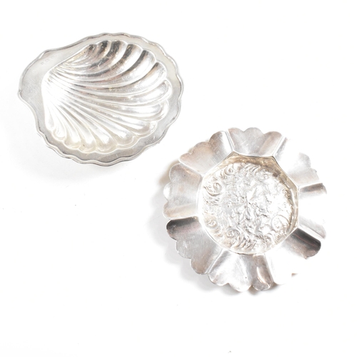 186 - Two hallmarked silver trinket dishes. The lot to include a George V dish in the form of a shell, rai... 