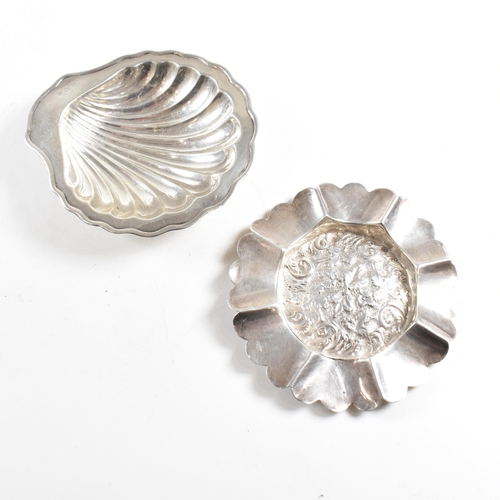 186 - Two hallmarked silver trinket dishes. The lot to include a George V dish in the form of a shell, rai... 