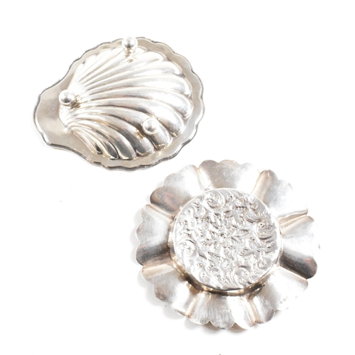 186 - Two hallmarked silver trinket dishes. The lot to include a George V dish in the form of a shell, rai... 