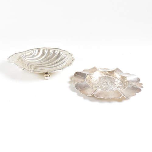 186 - Two hallmarked silver trinket dishes. The lot to include a George V dish in the form of a shell, rai... 