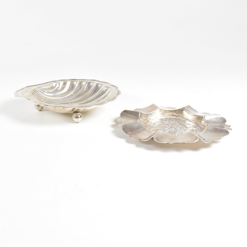 186 - Two hallmarked silver trinket dishes. The lot to include a George V dish in the form of a shell, rai... 