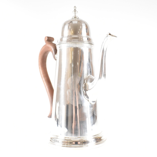 192 - A hallmarked silver Queen Anne style coffee pot. The coffee pot in round tapered form having a domed... 