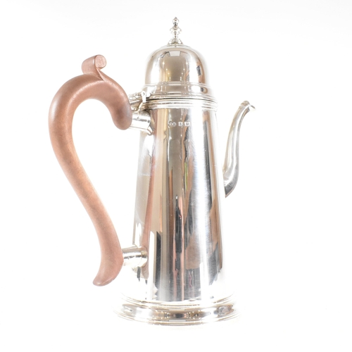 192 - A hallmarked silver Queen Anne style coffee pot. The coffee pot in round tapered form having a domed... 