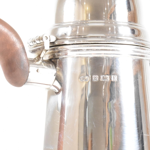 192 - A hallmarked silver Queen Anne style coffee pot. The coffee pot in round tapered form having a domed... 