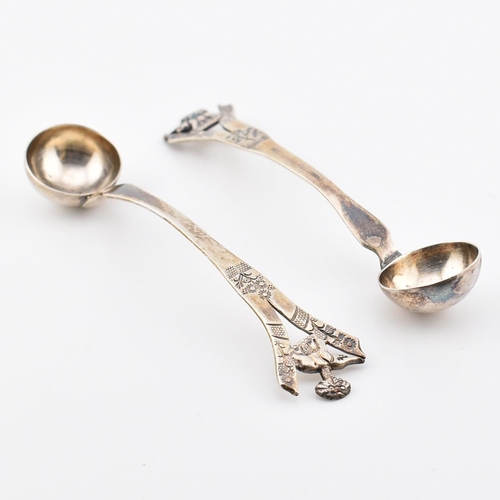 194 - A pair of Anglo-colonial Indian silver condiment ladles. Each with pierced handles having elephant a... 