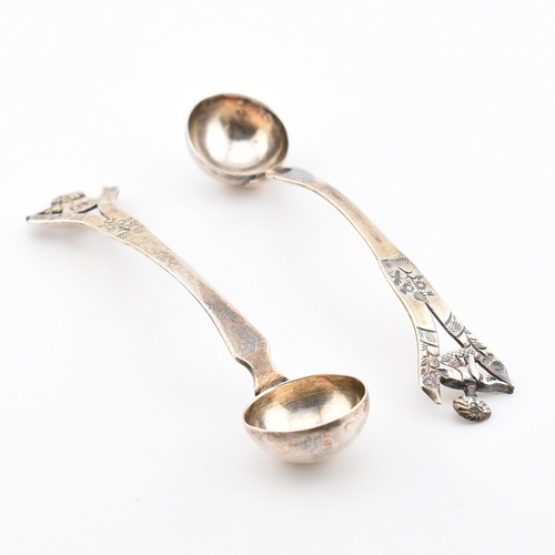 194 - A pair of Anglo-colonial Indian silver condiment ladles. Each with pierced handles having elephant a... 