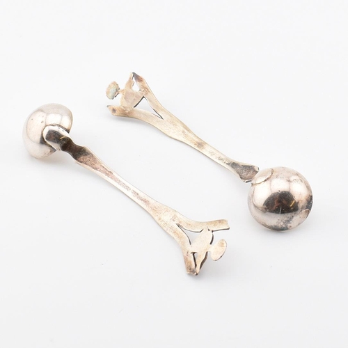 194 - A pair of Anglo-colonial Indian silver condiment ladles. Each with pierced handles having elephant a... 