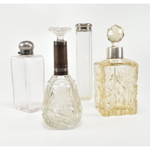 198 - A collection of silver four hallmarked cut glass ladies dressing table vanity bottles, perfume and p... 