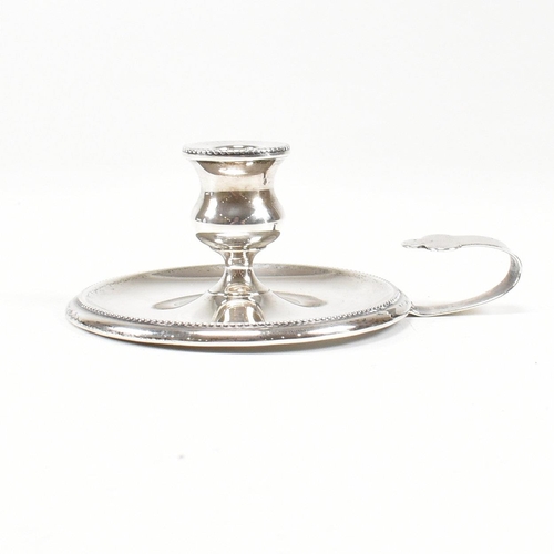 2 - A Victorian hallmarked silver taperstick. The taperstick miniature chamber candle stick on a circula... 