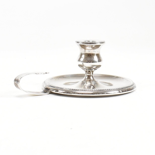 2 - A Victorian hallmarked silver taperstick. The taperstick miniature chamber candle stick on a circula... 