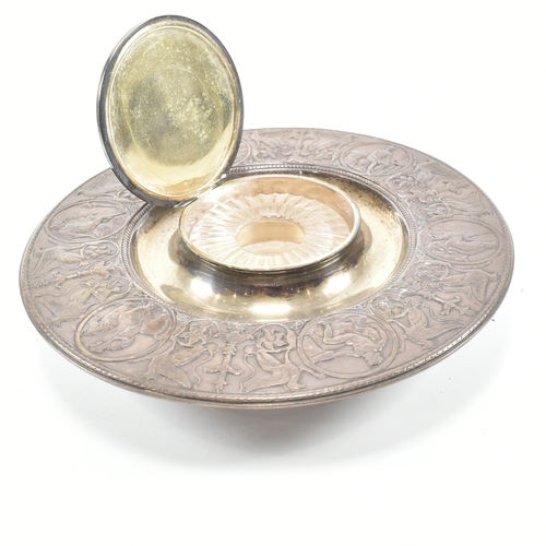 202 - A 19th century Victorian Elkington & Co ink stand. The ink stand of circular form decorated with neo... 