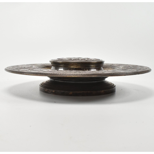 202 - A 19th century Victorian Elkington & Co ink stand. The ink stand of circular form decorated with neo... 