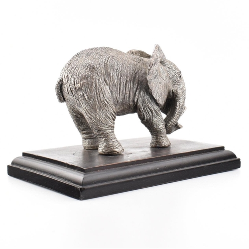 203 - A hallmarked silver Country Artists elephant figurine. The figurine of an Elephant mounted on a hard... 