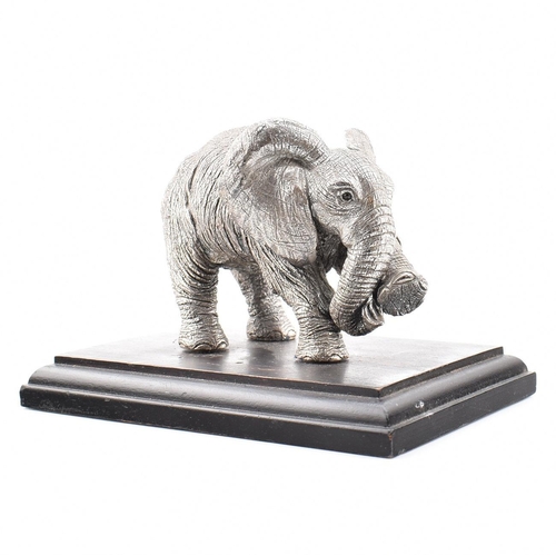 203 - A hallmarked silver Country Artists elephant figurine. The figurine of an Elephant mounted on a hard... 