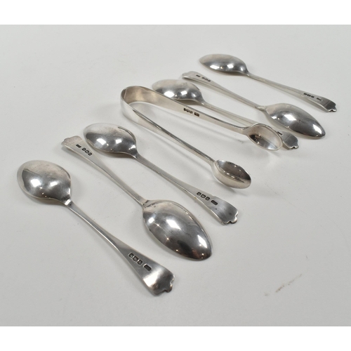 204 - A George V hallmarked silver set of dog nose coffee spoons and sugar tongs. The spoons having trifid... 