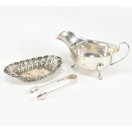 207 - A collection of early to mid century hallmarked silver items. The lot to include a silver sauce boat... 