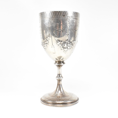 21 - A Victorian hallmarked silver goblet trophy. The goblet having a circular plinth base with baluster ... 