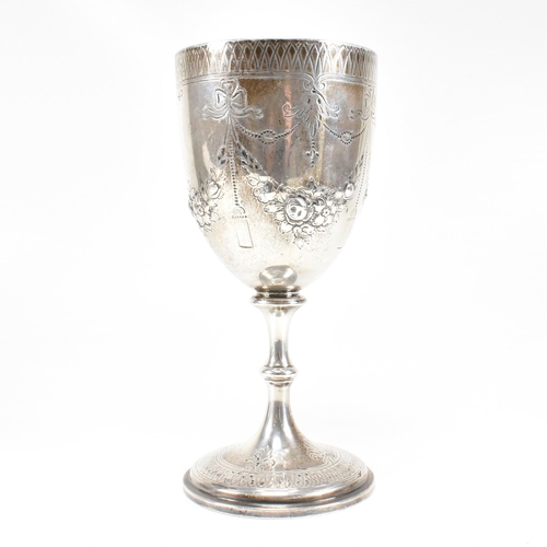 21 - A Victorian hallmarked silver goblet trophy. The goblet having a circular plinth base with baluster ... 