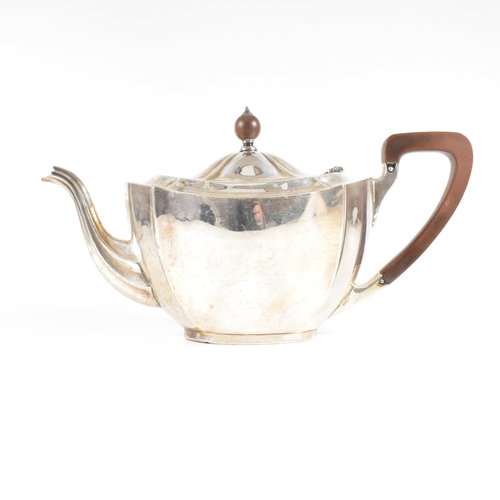 23 - A 1930s hallmarked silver tea pot. The George V tea pot sitting on an oval plinth base raising to a ... 