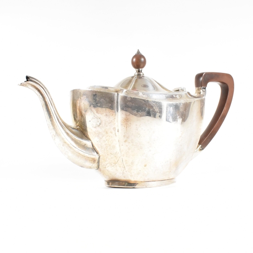 23 - A 1930s hallmarked silver tea pot. The George V tea pot sitting on an oval plinth base raising to a ... 