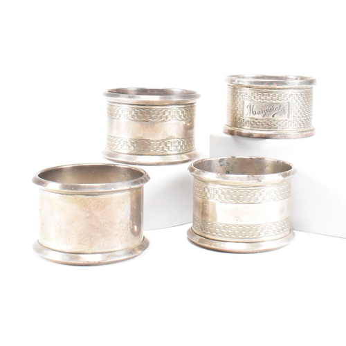 30 - Four Early 20th century hallmarked silver napkin rings. The lot to include a pair of George V hallma... 