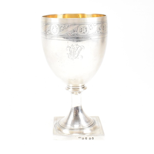 31 - A George III hallmarked silver goblet. The early 19th century goblet having a square plinth base ris... 