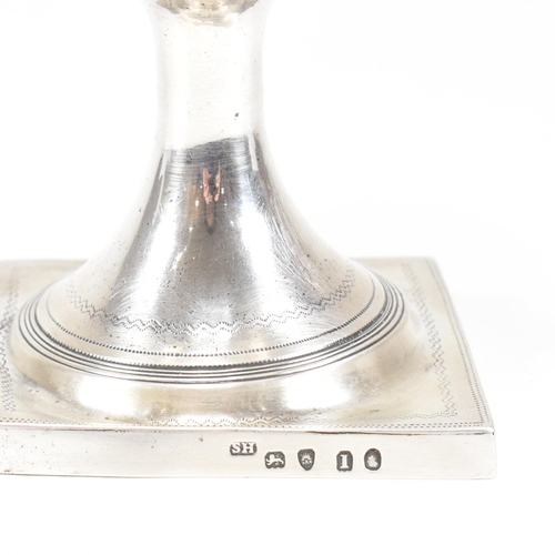 31 - A George III hallmarked silver goblet. The early 19th century goblet having a square plinth base ris... 