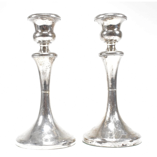 33 - A pair of George V hallmarked silver candlesticks. The candlesticks having a circular weighted base ... 