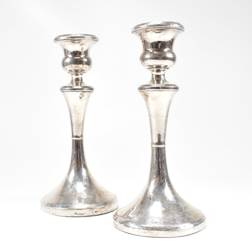 33 - A pair of George V hallmarked silver candlesticks. The candlesticks having a circular weighted base ... 