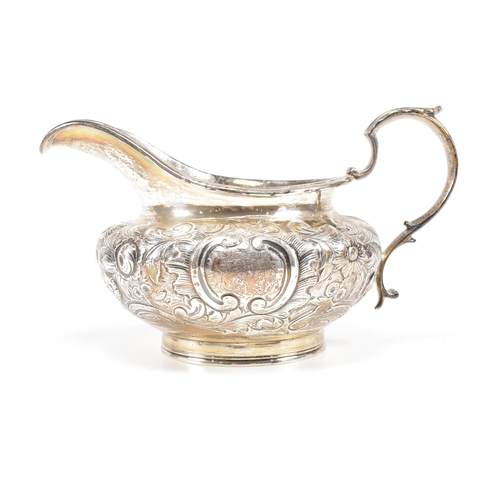 36 - A Victorian hallmarked silver creamer. The cream jug standing on a circular plinth rising to a bulbo... 