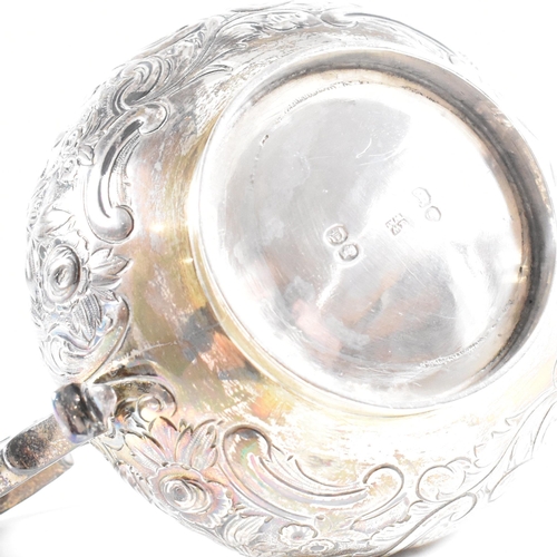 36 - A Victorian hallmarked silver creamer. The cream jug standing on a circular plinth rising to a bulbo... 