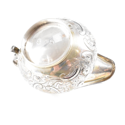 36 - A Victorian hallmarked silver creamer. The cream jug standing on a circular plinth rising to a bulbo... 