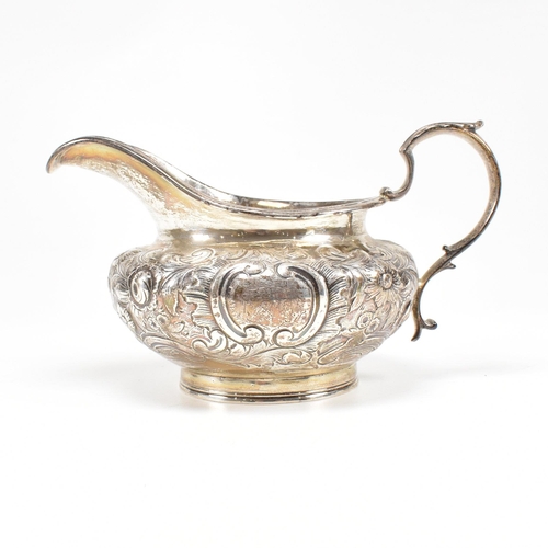 36 - A Victorian hallmarked silver creamer. The cream jug standing on a circular plinth rising to a bulbo... 