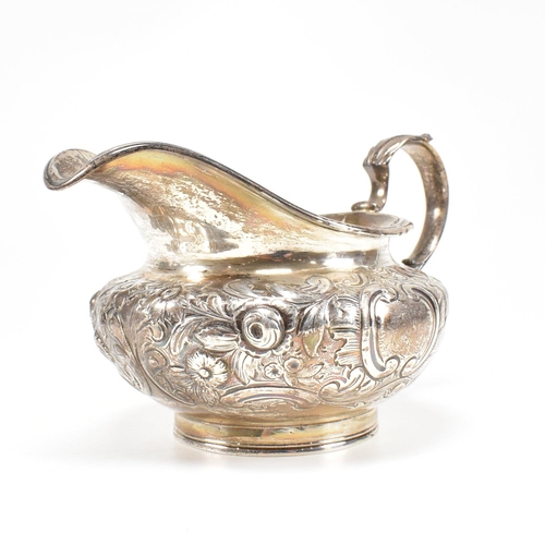 36 - A Victorian hallmarked silver creamer. The cream jug standing on a circular plinth rising to a bulbo... 