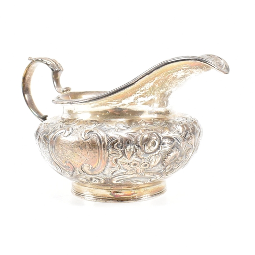 36 - A Victorian hallmarked silver creamer. The cream jug standing on a circular plinth rising to a bulbo... 