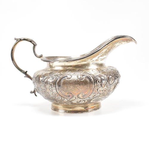 36 - A Victorian hallmarked silver creamer. The cream jug standing on a circular plinth rising to a bulbo... 