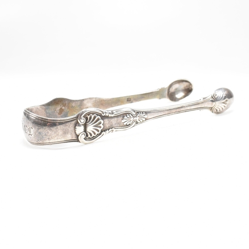 41 - One pair of Victorian and one pair of George IV hallmarked silver sugar tongs. Both tongs having mou... 