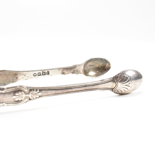 41 - One pair of Victorian and one pair of George IV hallmarked silver sugar tongs. Both tongs having mou... 