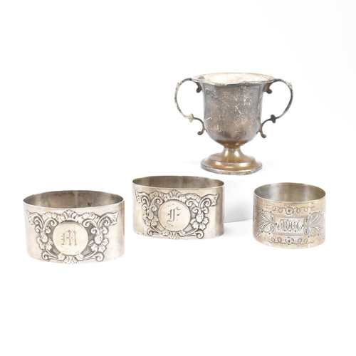 42 - Hallmarked silver napkin rings and trophy. The lot to include a pair of Edward VII silver napkin rin... 