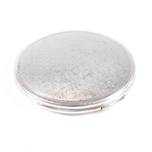 44 - A Mid century hallmarked silver compact. The compact being of circular form with hinged opening and ... 