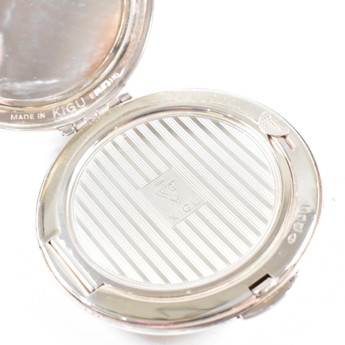 44 - A Mid century hallmarked silver compact. The compact being of circular form with hinged opening and ... 