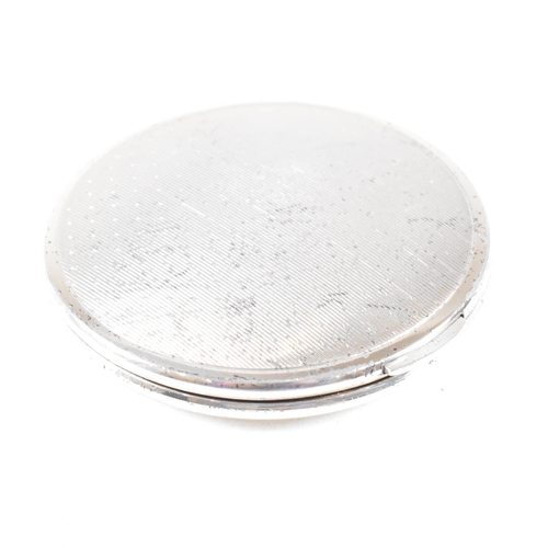 44 - A Mid century hallmarked silver compact. The compact being of circular form with hinged opening and ... 