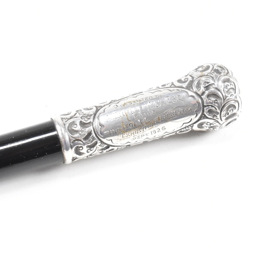 45 - A George V cased hallmarked silver and ebony conductors baton. The baton having a silverÿpommel and ... 