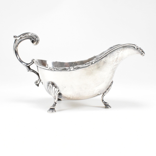 46 - A George V hallmarked silver sauce boat. The sauce or gravy boat having three hoof feet raising to a... 