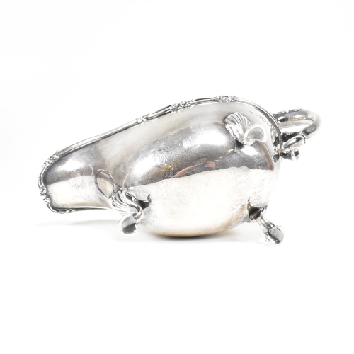 46 - A George V hallmarked silver sauce boat. The sauce or gravy boat having three hoof feet raising to a... 