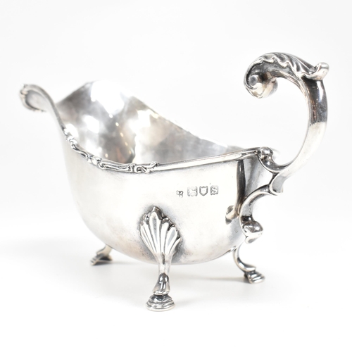 46 - A George V hallmarked silver sauce boat. The sauce or gravy boat having three hoof feet raising to a... 